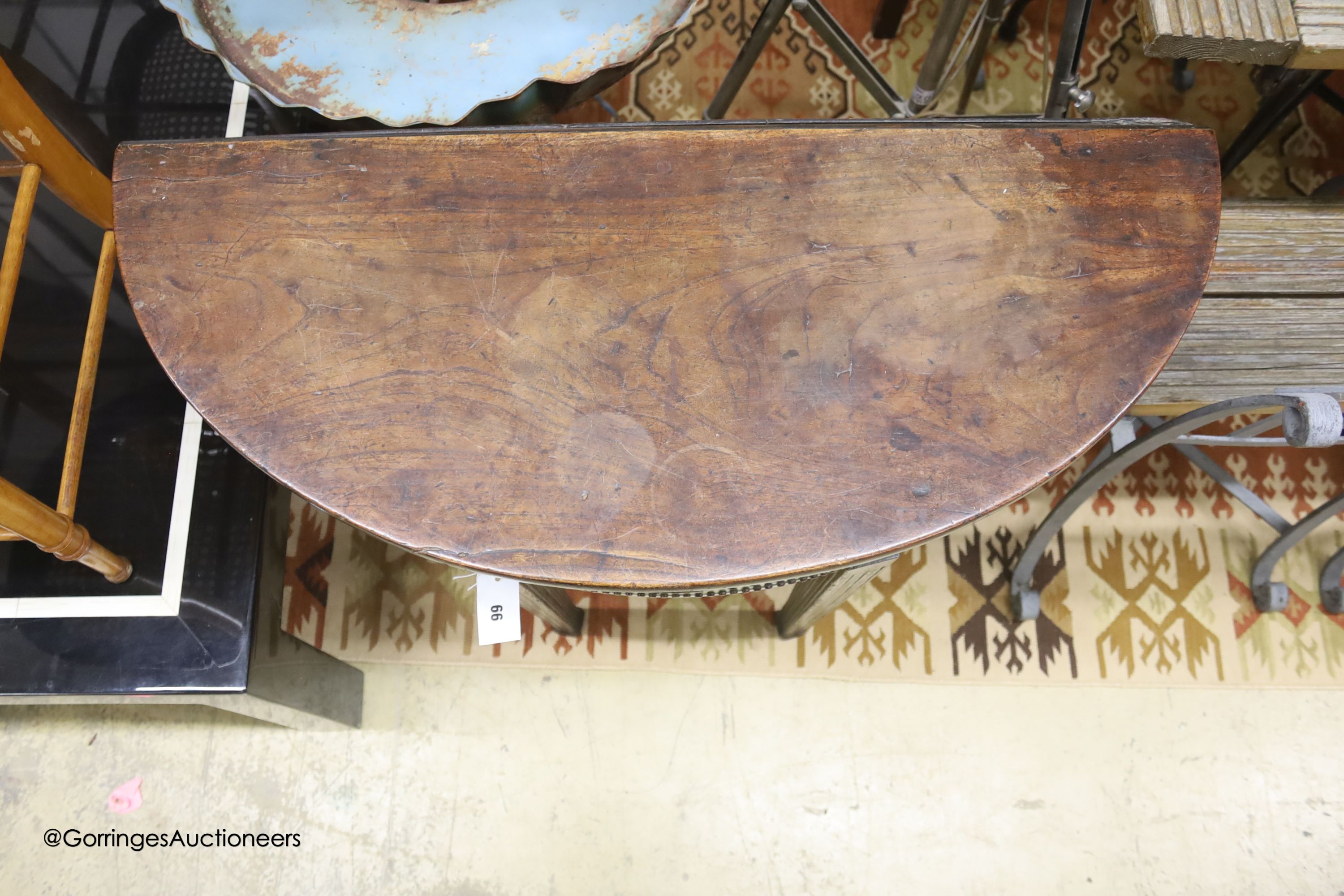 A George III mahogany 'D' shaped drop flap tea table, fitted with one drawer, width 88cm, depth 36cm, height 74cm